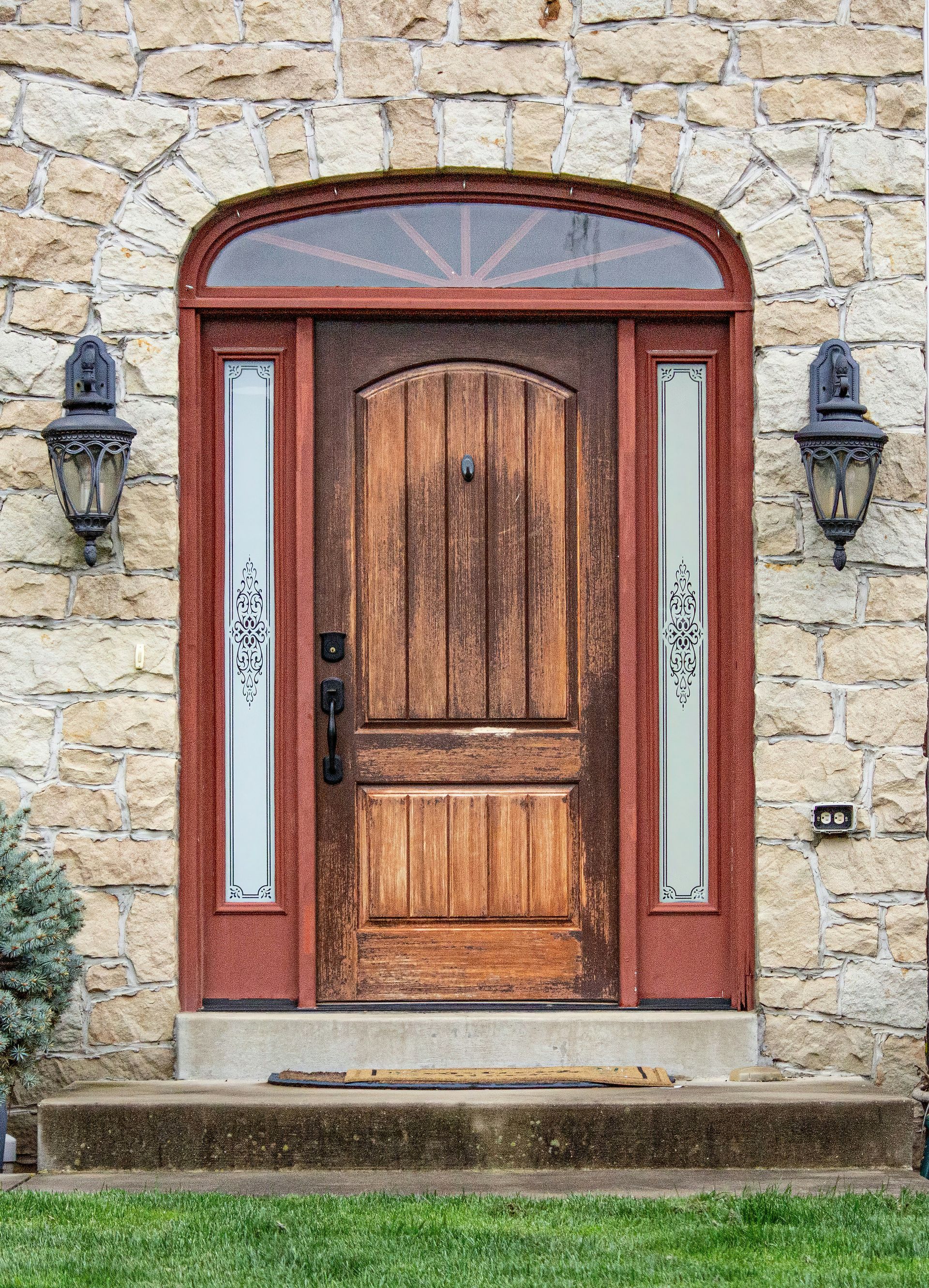 a wooden door sitting next to a stone building